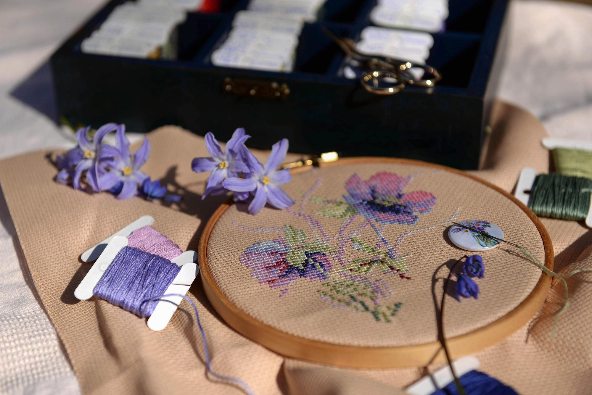 Large editorial shot of embroidered textile art displayed in a gallery