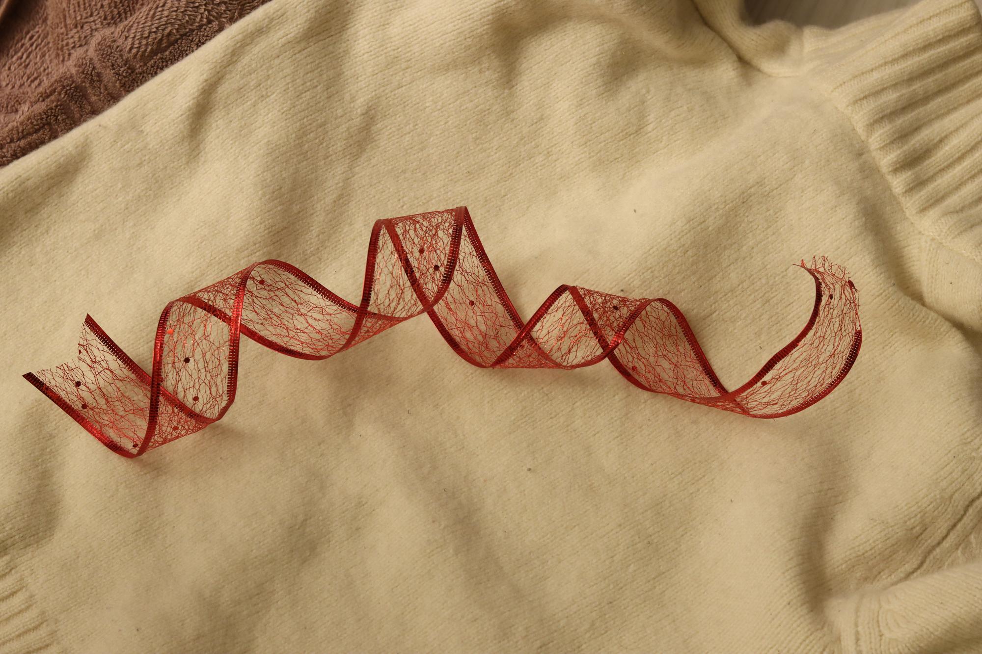 Close-up of hand embroidery on linen with warm tones